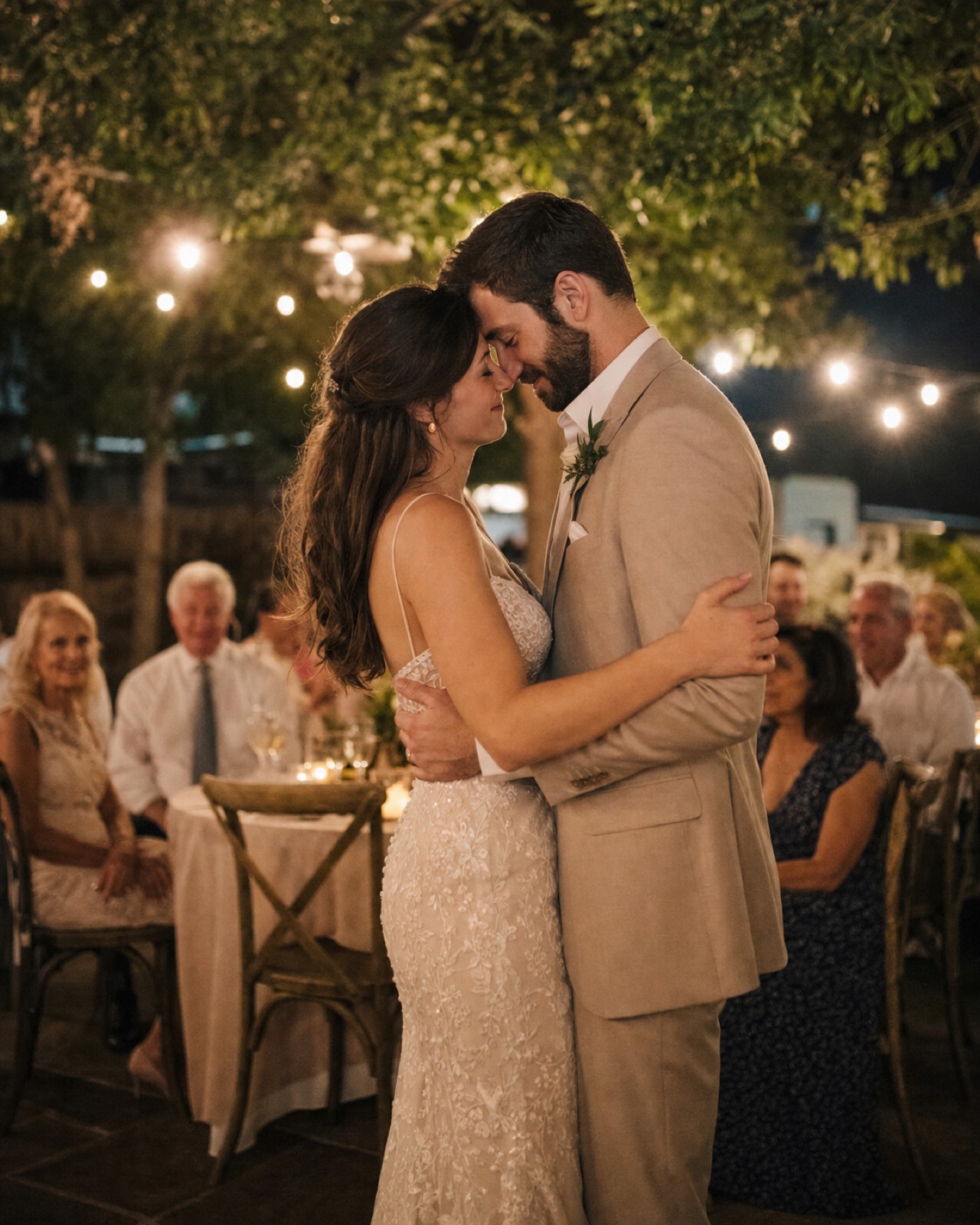 A first dance under string lights, showing on the bedroom TV